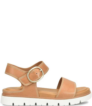 Tan sandal with a gold buckle on a white background
