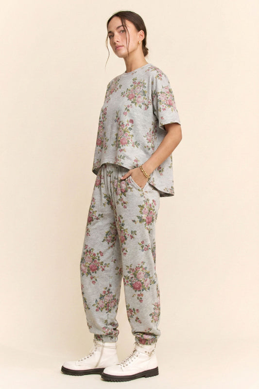 Person wearing a floral outfit with a plain background