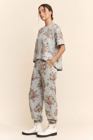 Person wearing a floral outfit with a plain background