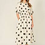 Woman wearing a polka dot dress on a white background