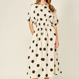 Woman wearing a polka dot dress on a white background