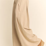Beige wide-leg pants worn by a person on a plain background