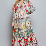 Woman wearing a colorful floral dress on a gray background