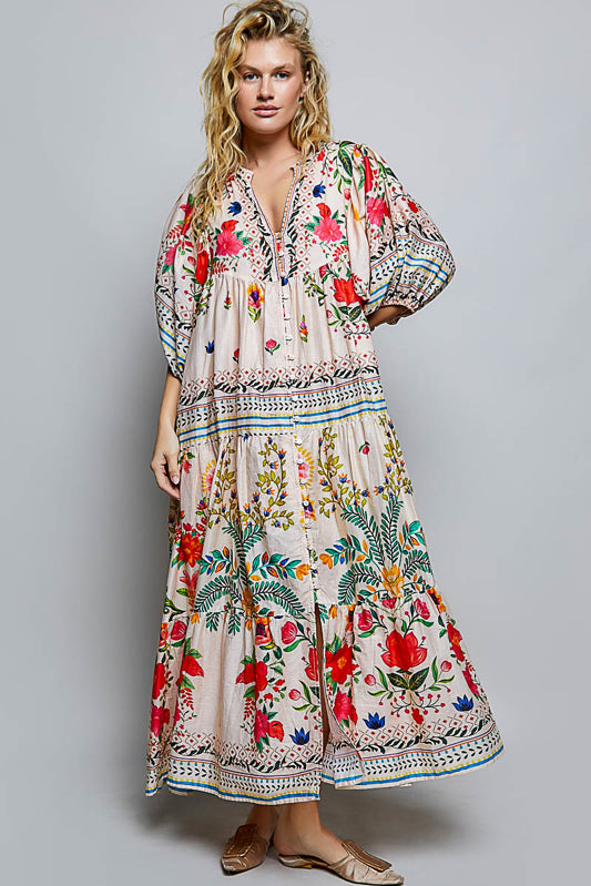 Woman wearing a colorful floral dress on a gray background