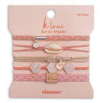 Packaged hair tie and bracelet set with shell and leaf charms on a pink background