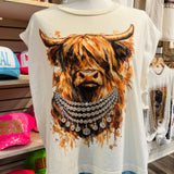Mannequin wearing a t-shirt with a highland cow design in a store setting