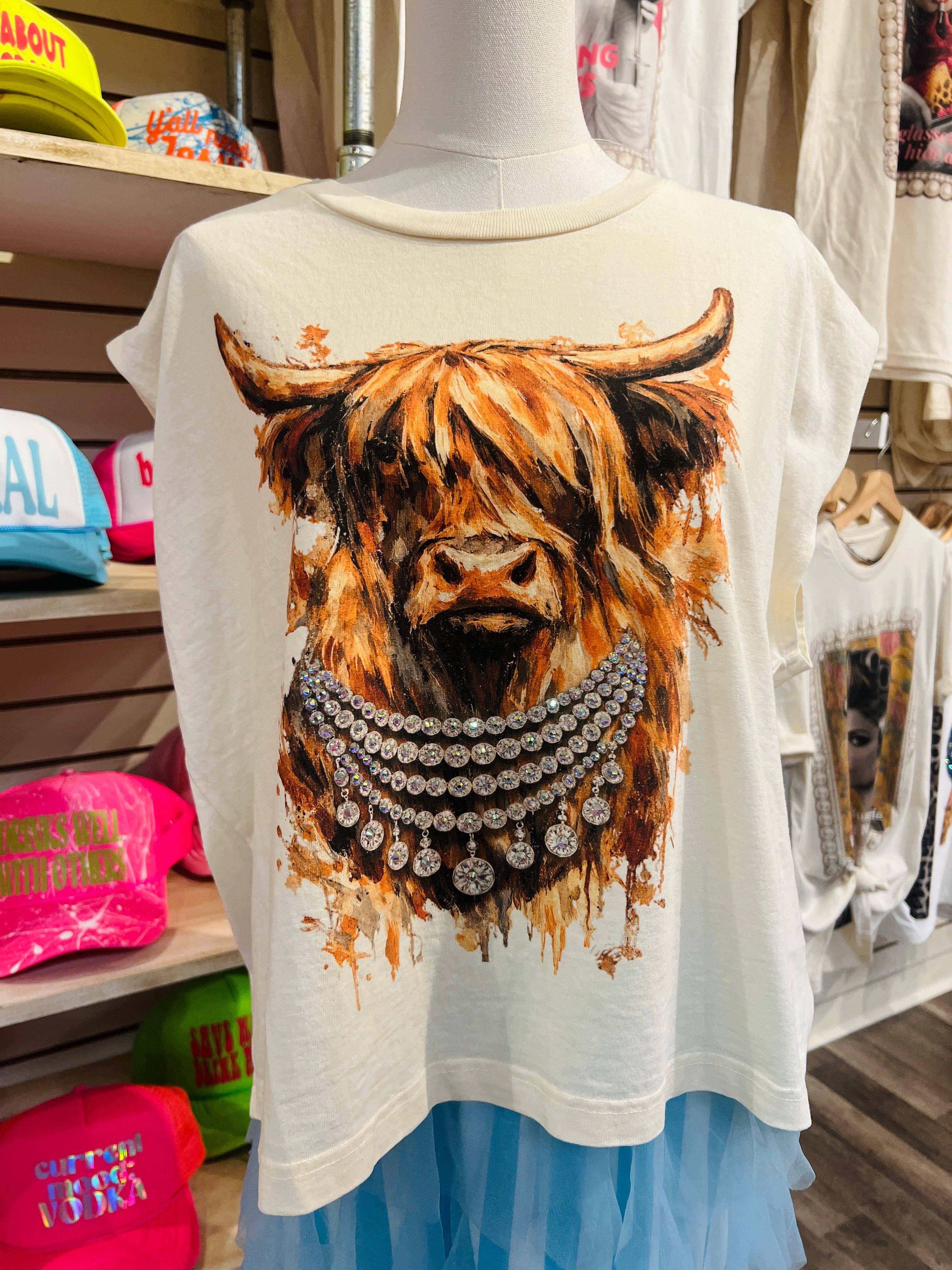 Mannequin wearing a t-shirt with a highland cow design in a store setting