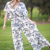 Woman wearing a white outfit with black patterns in a park