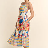 Woman wearing a colorful floral dress with a striped pattern on a beige background