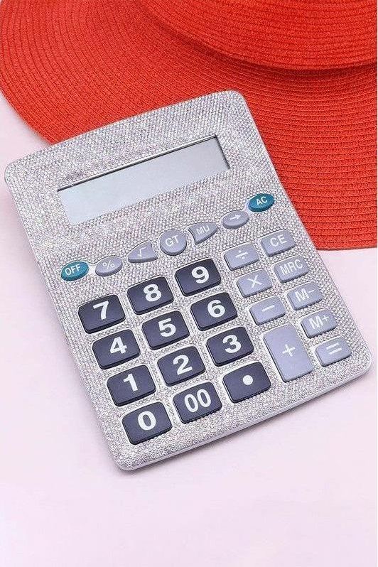 Silver calculator with blue buttons on a pink background