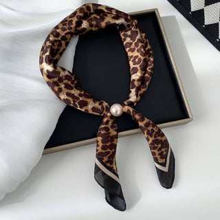 Leopard print scarf with a pearl knot on a black box