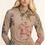 Woman wearing a long-sleeve shirt with horse prints on a beige background