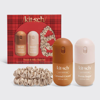 Akit-sch Sweet & Silky Hair Set featuring a red plaid gift box, two hair perfume bottles (Caramel Cream and Warm Sugar), and two beige satin scrunchies on a light gray background.