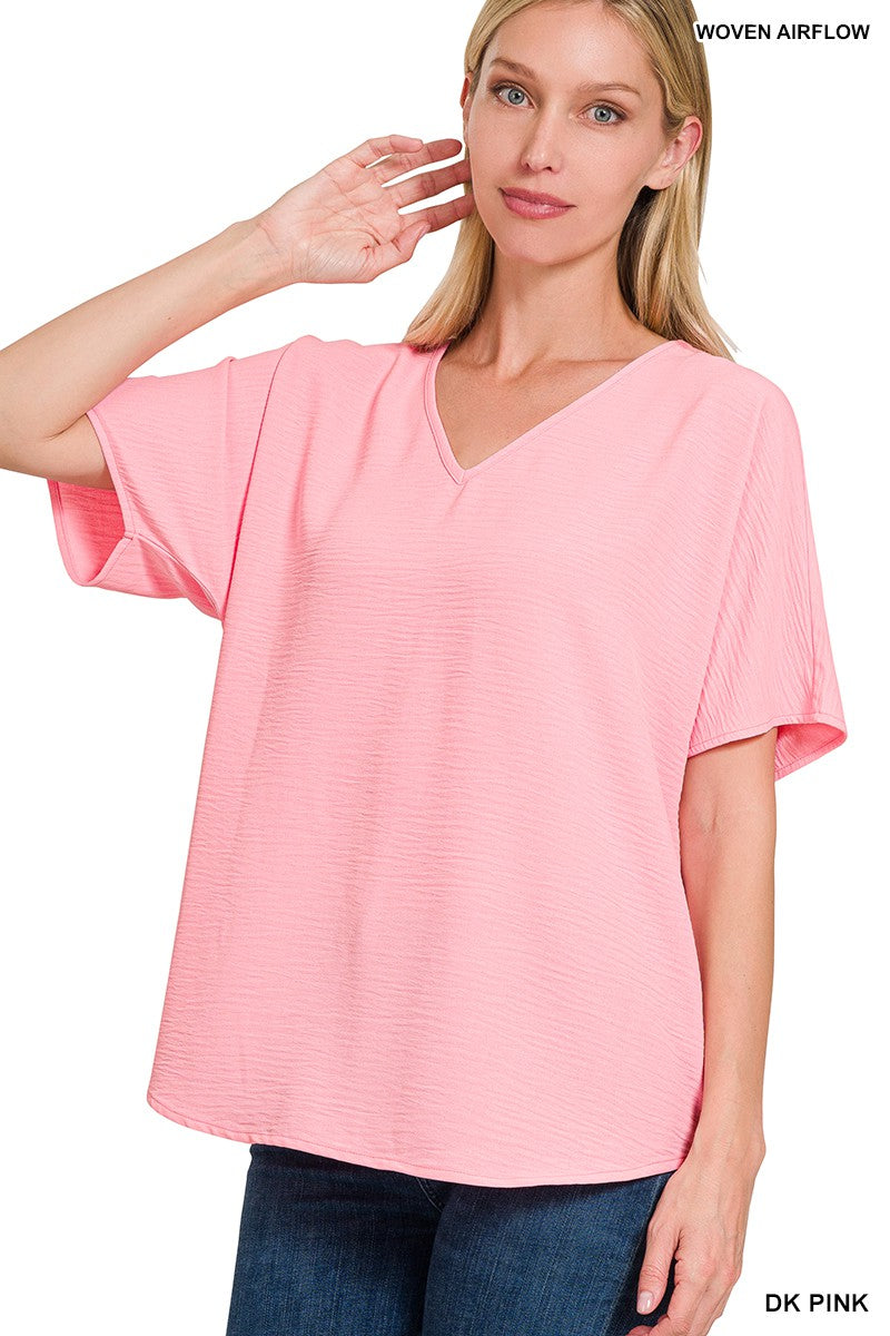 Woman wearing a pink blouse with text 'Woven Airflow' and 'DK Pink' on a white background