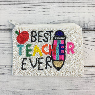 Beaded pouch with 'Best Teacher Ever' text and graphics on a wooden surface