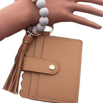 Mocha-colored wallet with tassel and keychain on a white background