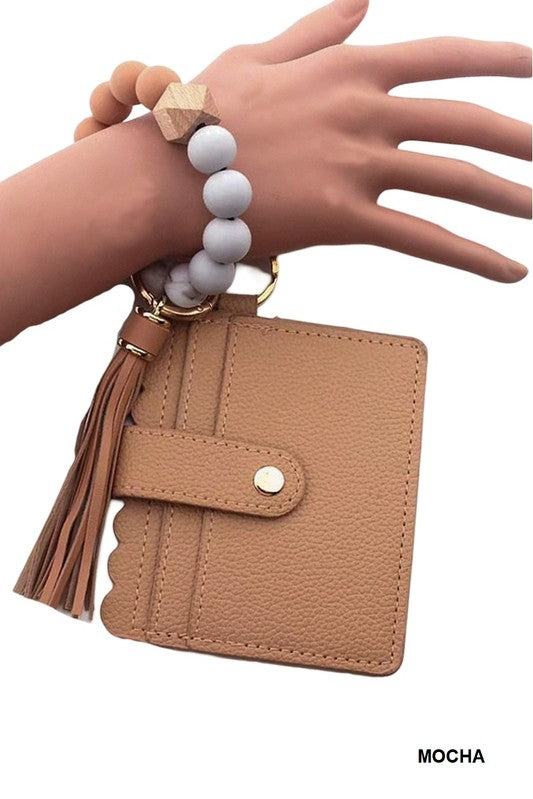 Mocha-colored wallet with tassel and keychain on a white background