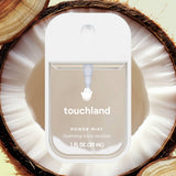 Touchland power mist hand sanitizer packaging inside a coconut shell