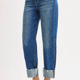 Blue jeans with rolled-up cuffs on a white background