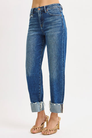 Blue jeans with rolled-up cuffs on a white background