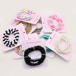 Collection of beaded PHONE CHARGERS 
on pink cards with a white background