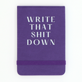 Purple notebook with white text 'WRITE THAT SHIT DOWN' on a white background