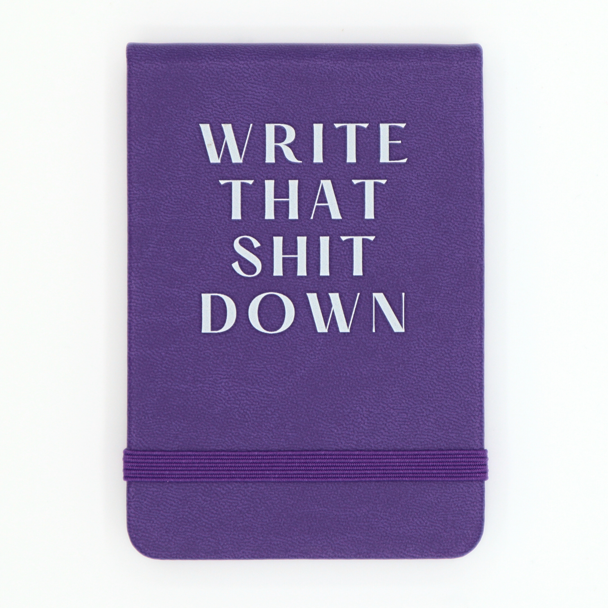 Purple notebook with white text 'WRITE THAT SHIT DOWN' on a white background