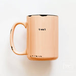 Copper mug with 'twat' printed on a white background