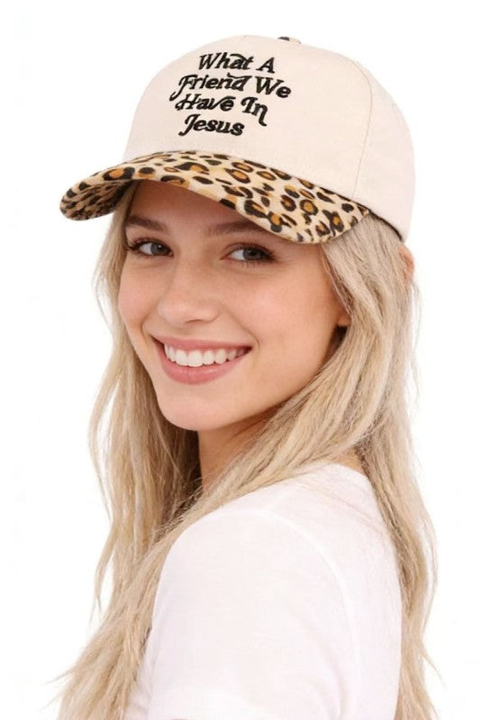 Woman wearing a beige cap with leopard print brim and text, on a white background