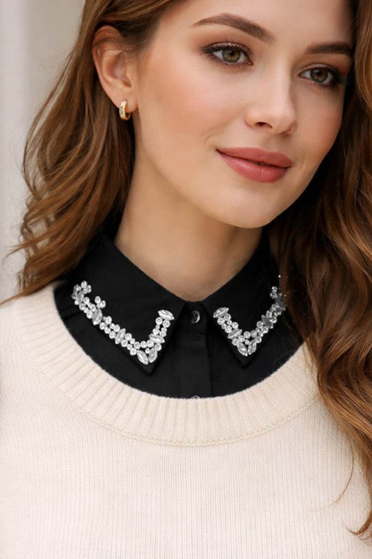Woman wearing a black blouse with a decorative collar