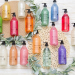 Assorted colorful bottles on a decorative background with greenery