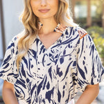 Woman wearing a patterned blouse outdoors