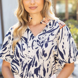 Woman wearing a patterned blouse outdoors