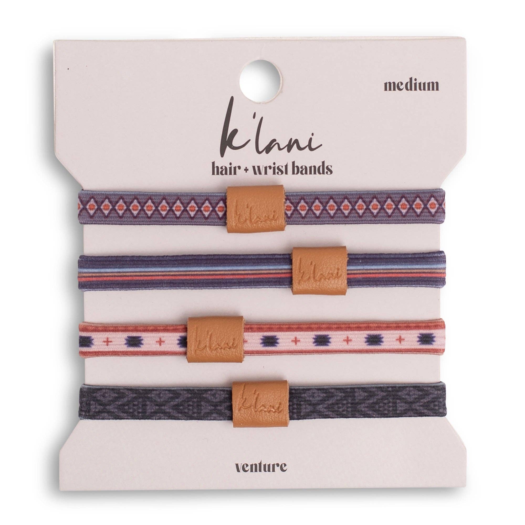 Set of three patterned hair or wrist bands with brown leather ends on a 'ká lani' branded card.