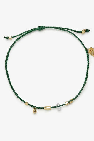 Green bracelet with gold accents on a white background
