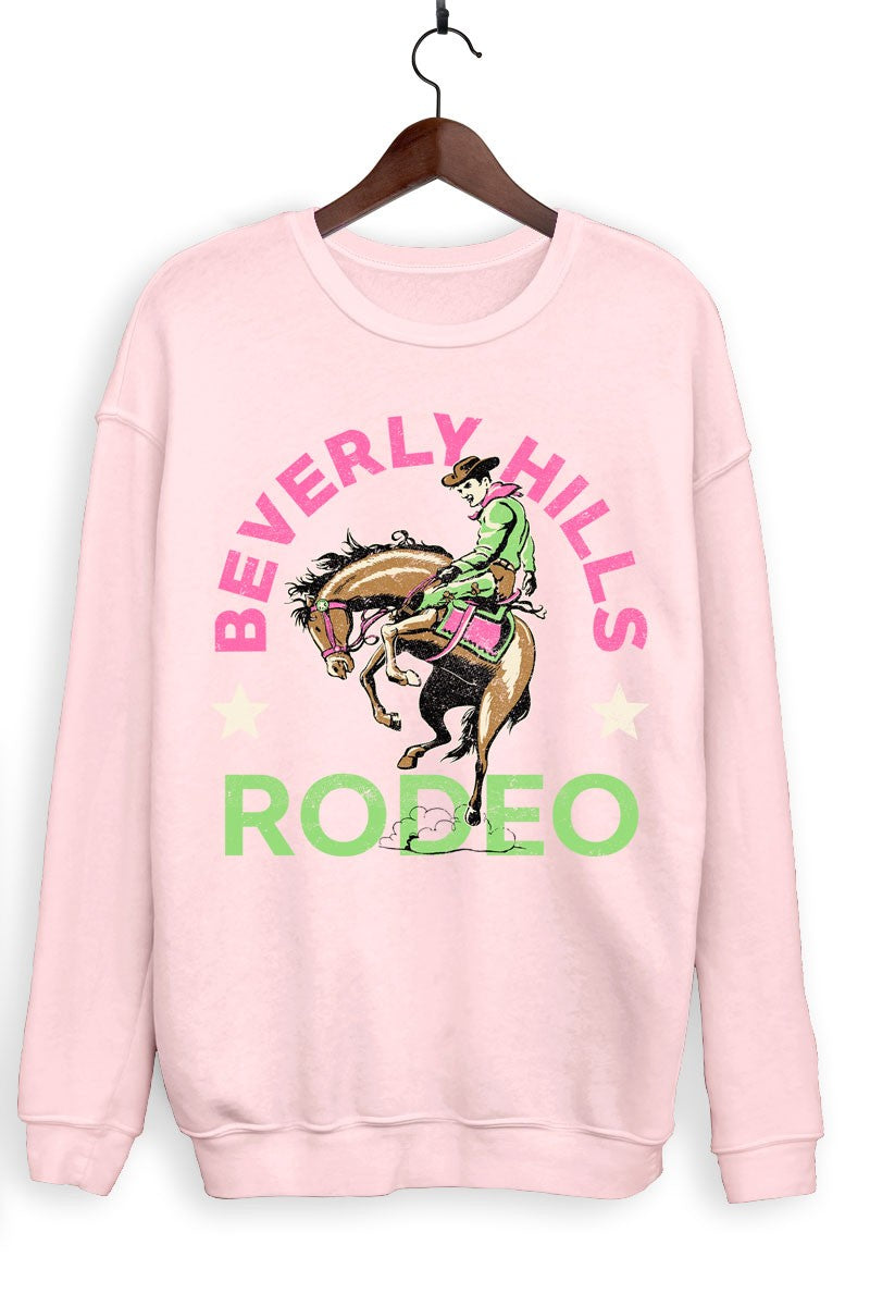 Pink sweatshirt with 'Beverly Hills Rodeo' graphic on a hanger against a white background