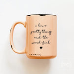 Rose gold mug with black text on a white background