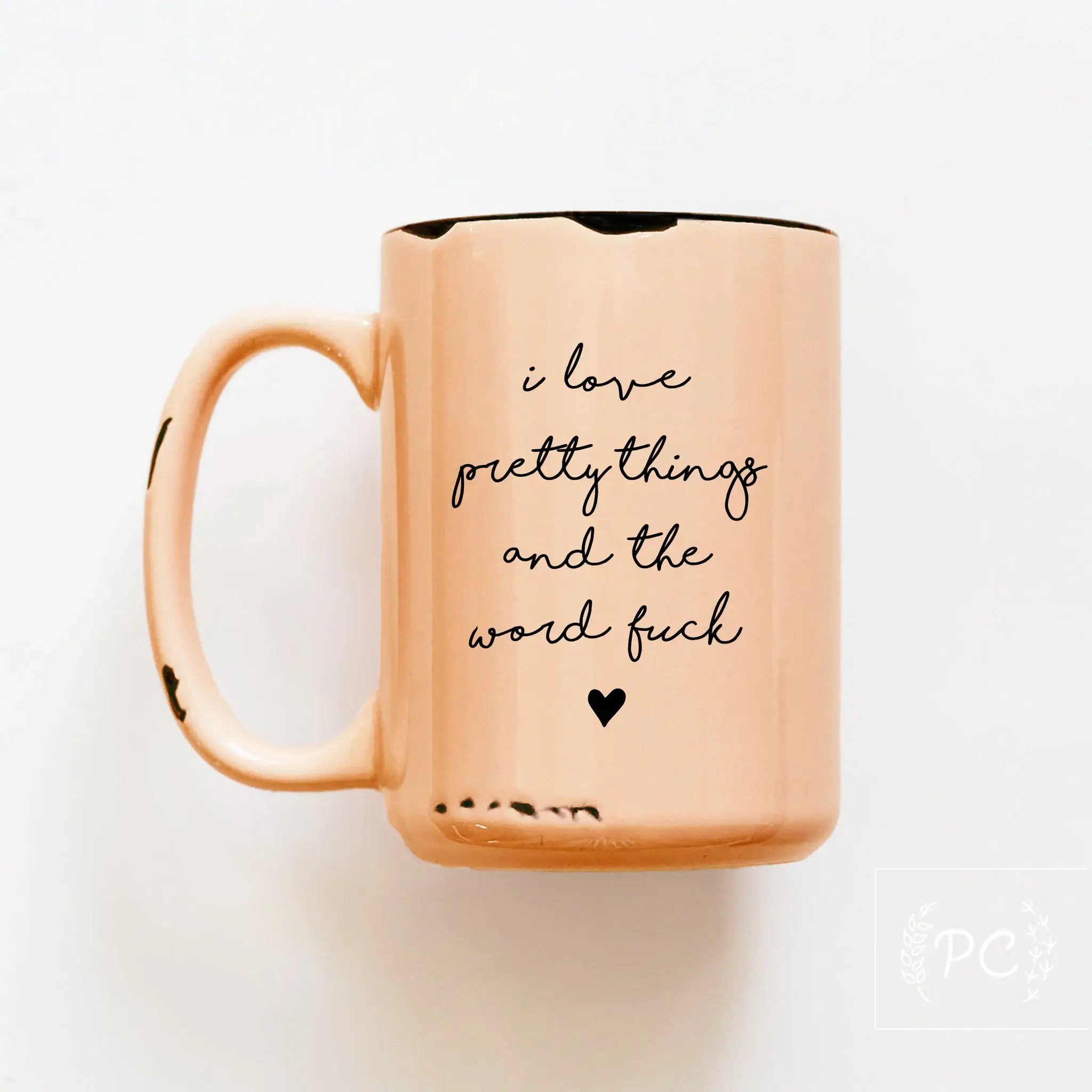Rose gold mug with black text on a white background