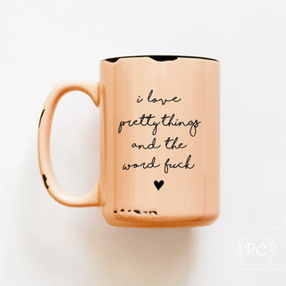 Rose gold mug with black text on a white background