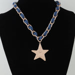Necklace with blue chain and star pendant on a black mannequin
