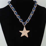 Necklace with blue chain and star pendant on a black mannequin