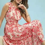 Woman wearing a red and white floral dress against a light blue background