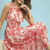 Woman wearing a red and white floral dress against a light blue background