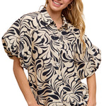 Woman wearing a patterned blouse with a pink background