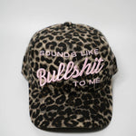 Leopard print cap with text 'SOUNDS LIKE BULLSHIT TO ME' on a white background