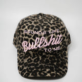 Leopard print cap with text 'SOUNDS LIKE BULLSHIT TO ME' on a white background