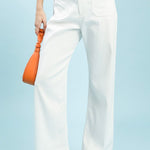 Person wearing off-white pants with a light blue background