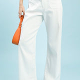 Person wearing off-white pants with a light blue background
