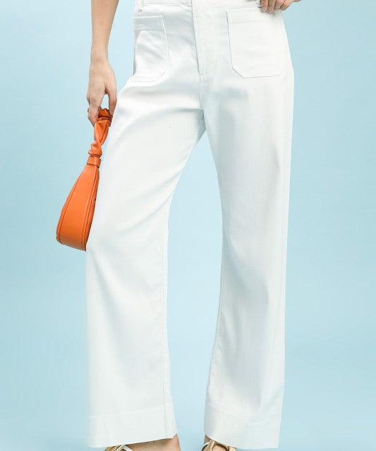 Person wearing off-white pants with a light blue background