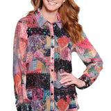 Woman wearing a colorful patterned shirt on a white background
